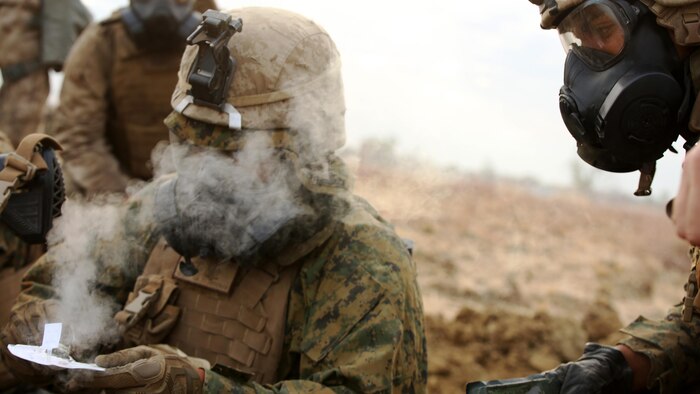 A Marine with Company C, 1st Battalion, 1st Marine Regiment, tests the air for safety after a gas attack August 18, 2016, at Bradshaw Field Training Area, Northern Territory, Australia. The range was the final training evolution of Exercise Koolendong 16, a trilateral exercise between the U.S. Marine Corps, Australian Defence Force and French Armed Forces New Caledonia. Marines held a defensive position while engaging targets and working through the CS gas, which simulated a chemical attack. 
