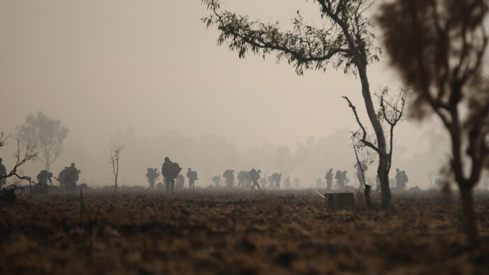 Marines with Company C, 1st Battalion, 1st Marine Regiment pack up their gear after completing the final live fire range of Exercise Koolendong 16 at Bradshaw Field Training Area, Northern Territory, Australia on August 18, 2016. The range was the final training evolution of Exercise Koolendong 16, a trilateral exercise between the U.S. Marine Corps, Australian Defence Force and French Armed Forces New Caledonia. Marines held a defensive position while engaging targets and working through the CS gas, which simulated a chemical attack.