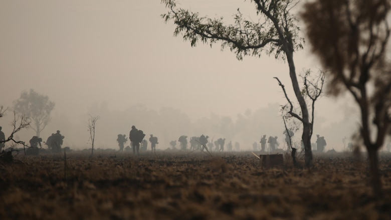 Marines with Company C, 1st Battalion, 1st Marine Regiment pack up their gear after completing the final live fire range of Exercise Koolendong 16 at Bradshaw Field Training Area, Northern Territory, Australia on August 18, 2016. The range was the final training evolution of Exercise Koolendong 16, a trilateral exercise between the U.S. Marine Corps, Australian Defence Force and French Armed Forces New Caledonia. Marines held a defensive position while engaging targets and working through the CS gas, which simulated a chemical attack.