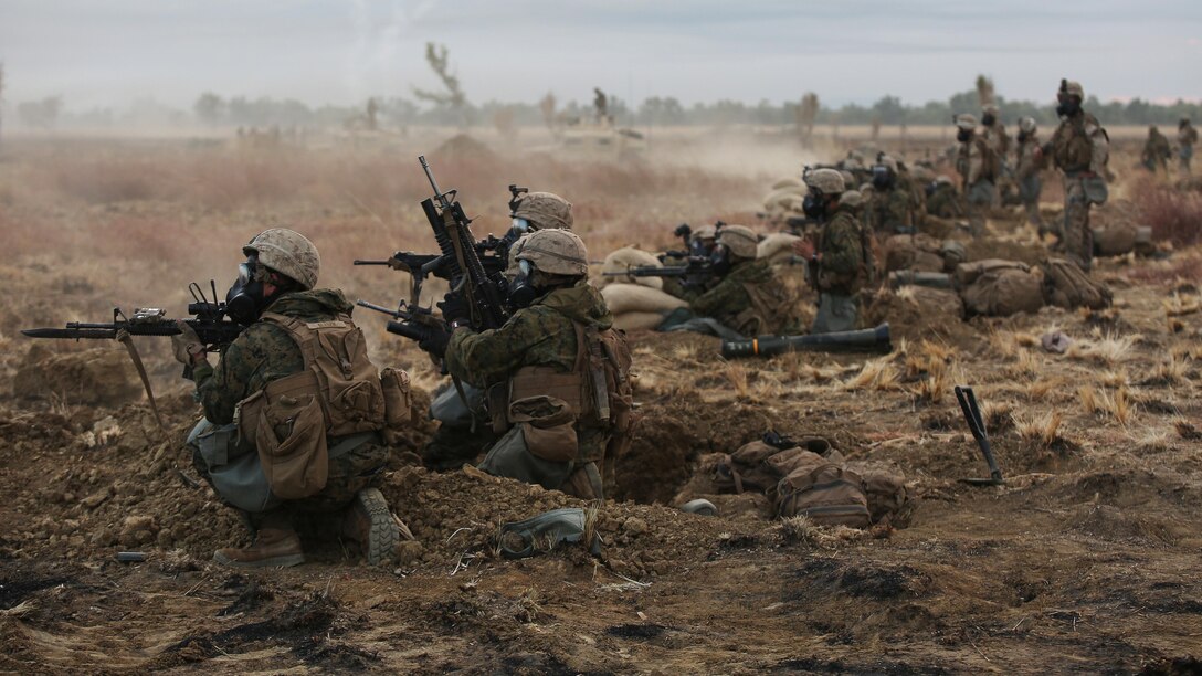 Marines with Company C, 1st Battalion, 1st Marine Regiment, fire down range during a CS gas attack during a live fire range August 18, 2016, at Bradshaw Field Training Area, Northern Territory, Australia. The range was the final training evolution of Exercise Koolendong 16, a trilateral exercise between the U.S. Marine Corps, Australian Defence Force and French Armed Forces New Caledonia. Marines held a defensive position while engaging targets and working through the CS gas, which simulated a chemical attack.