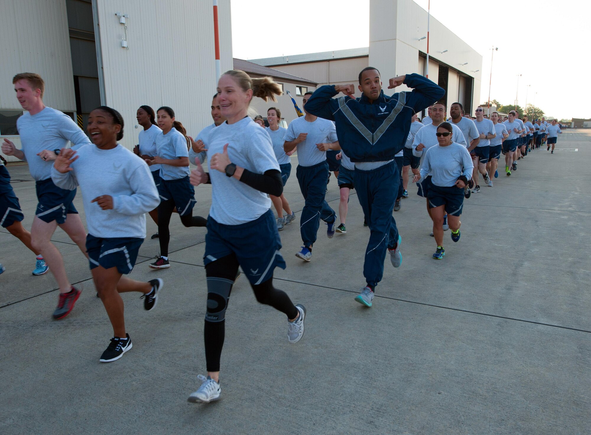 Airmen run the flightline during a tri-wing run Aug. 18, 2016, at Ramstein Air Base, Germany. The 1.8 mile event, which aims to promote camaraderie and physical fitness, included Airmen from the 86th Airlift Wing, 435th Air Ground Operations Wing and 521st Air Mobility Operations Wing. (U.S. Air Force photo/Staff Sgt. Sharida Jackson)