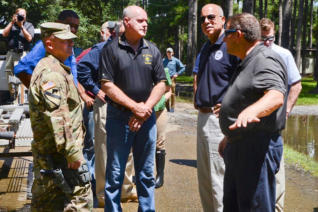 Army Lt. Col. Cameron Magee, left, and James Leblanc, center, the fire chief of St. Amant's volunteer fire department, show U.S. Homeland Security Secretary Jeh Johnson, center right, the impact of flooding in neighborhoods in St. Amant, La., Aug. 18, 2016. Heavy rains in the region caused severe flooding. Magee is commander of the Louisiana National Guard's 2nd Squadron, 108th Cavalry Regiment. Army National Guard photo by Sgt. Noshoba Davis