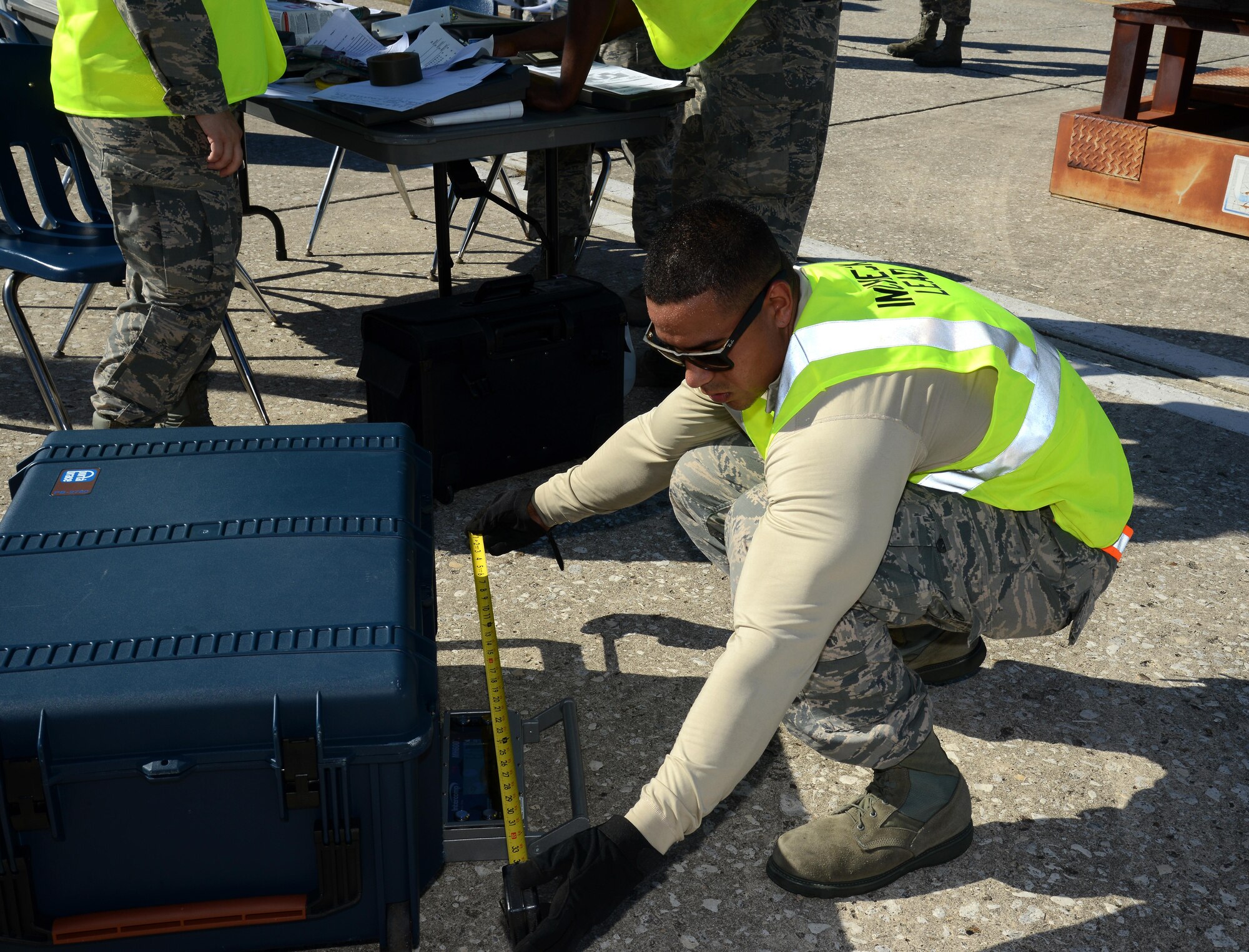Staff Sgt. Allan Canizales, a mobility training instructor assigned to the 6th Logistics Readiness Squadron, weighs and measures cargo during a mobility exercise at MacDill Air Force Base, Fla., Aug. 16, 2016. Canizales was in charge of checking that all equipment being processed is documented with accurate size and weight measurements. (U.S. Air Force Photo by Airman 1st Class Rito Smith)