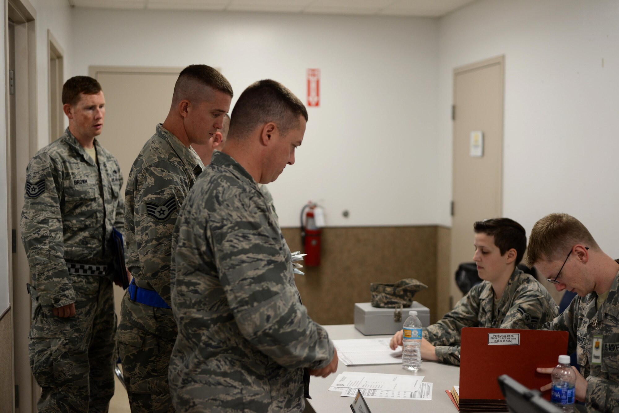 Members of Team MacDill walk through a pre-deployment line during a mobility exercise at MacDill Air Force Base, Fla., Aug. 16, 2016. Pre-deployment lines ensured that all Airmen getting ready to deploy had the required documents prior to departure. (U.S. Air Force Photo by Airman 1st Class Rito Smith)