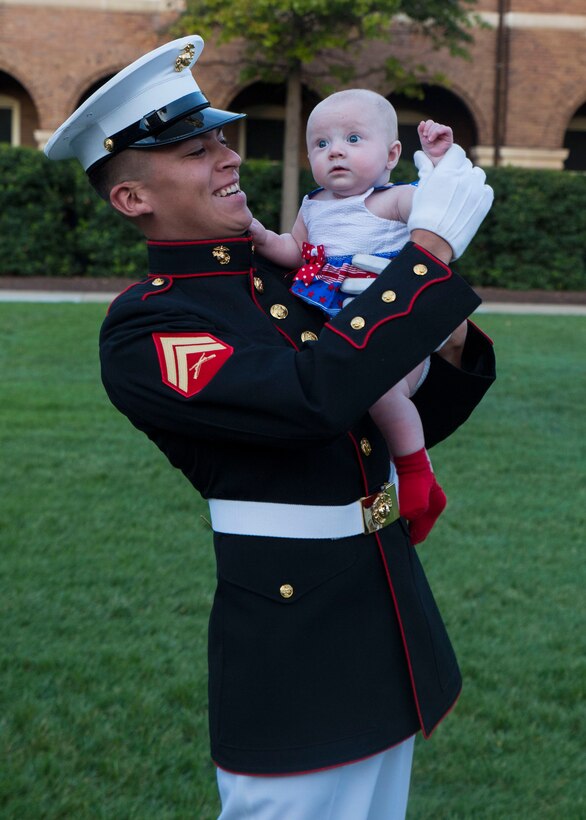 U.S. Marine Corps Corporal Fernando Maldonado, crowd educator, interacts with guests before the Noncommissioned Officer's parade Aug. 19, 2016. The guest of honor for the parade was Adm. John M. Richardson, chief of Naval Operations, and the hosting official was Gen. Robert B. Neller, commadant of the Marine Corps. (Official Marine Corps photo by Cpl. Andrianna Daly/Released)