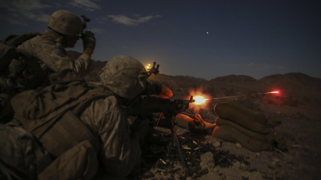 Lance Cpl. Login Loftis, a machine gunner with Company F, 2nd Battalion 5th Marine Regiment fires a M240 medium machine gun as Lance Cpl. Krikland Harrington, a machine gunner with Company F, 2/5, looks through his night vision optic to guide Loftis onto his target during Integrated Training Exercise 5-16 aboard Marine Air-Ground Combat Center Twentynine Palms Calif., Aug. 18, 2016.  ITX is designed to bring together the ground combat, air combat and logistics combat elements of the Marine Corps into one fully capable and lethal unit ready to respond to global uncertainty.