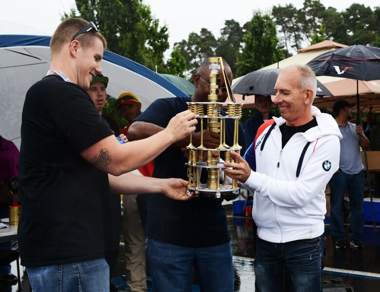 Patrick Sliwinski, right, 86th Vehicle Readiness Squadron Auto Show participant, receives the Best Overall award Aug. 20, 2016, at Ramstein Air Base, Germany. Sliwinski showcased his 1999 BMW E46 328Ci at the 10th annual 86th VRS Auto Show. (U.S. Air Force photo/ Airman 1st Class Joshua Magbanua)