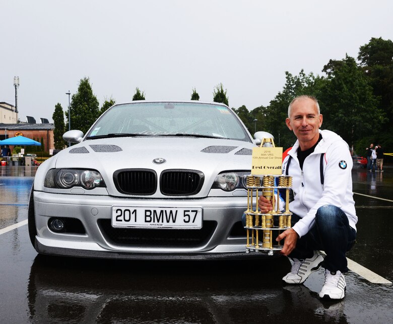 Patrick Sliwinski, 86th Vehicle Readiness Squadron Auto Show, poses next to his 1999 BMW E46 328Ci Aug. 20, 2016, at Ramstein Air Base, Germany. Sliwinski won the Best Overall award at the 10th annual 86th Vehicle Readiness Squadron Auto Show. (U.S. Air Force photo/ Airman 1st Class Joshua Magbanua)