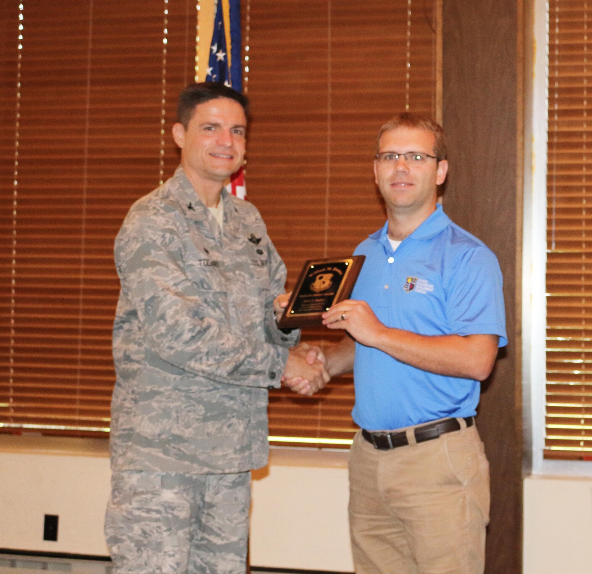 Kirk Butler (right), a scramjet test engineer at AEDC, accepts the William M. Dunne People’s Choice Award from AEDC Commander Col. Rodney Todaro at the AEDC Quarterly Awards Breakfast July 27 at the Arnold Lakeside Center. This image was cropped to emphasize the subject. (U.S. Air Force photo/Holly Peterson)