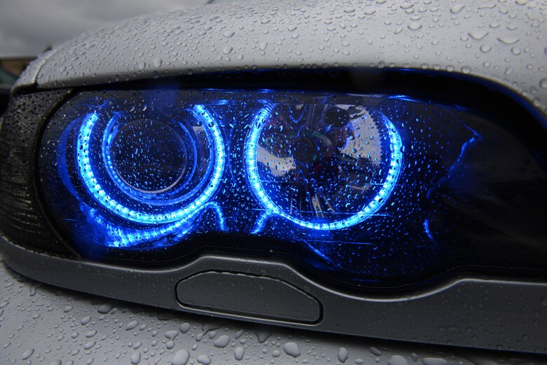 A 1999 BMW E46 328Ci headlight shines blue light during the 86th Vehicle Readiness Squadron Auto Show Aug. 20, 2016, at Ramstein Air Base, Germany. Approximately 180 participants from around the Kaiserslautern Military Community and Europe attended the 10th annual auto show. (U.S. Air Force photo/ Airman 1st Class Joshua Magbanua)