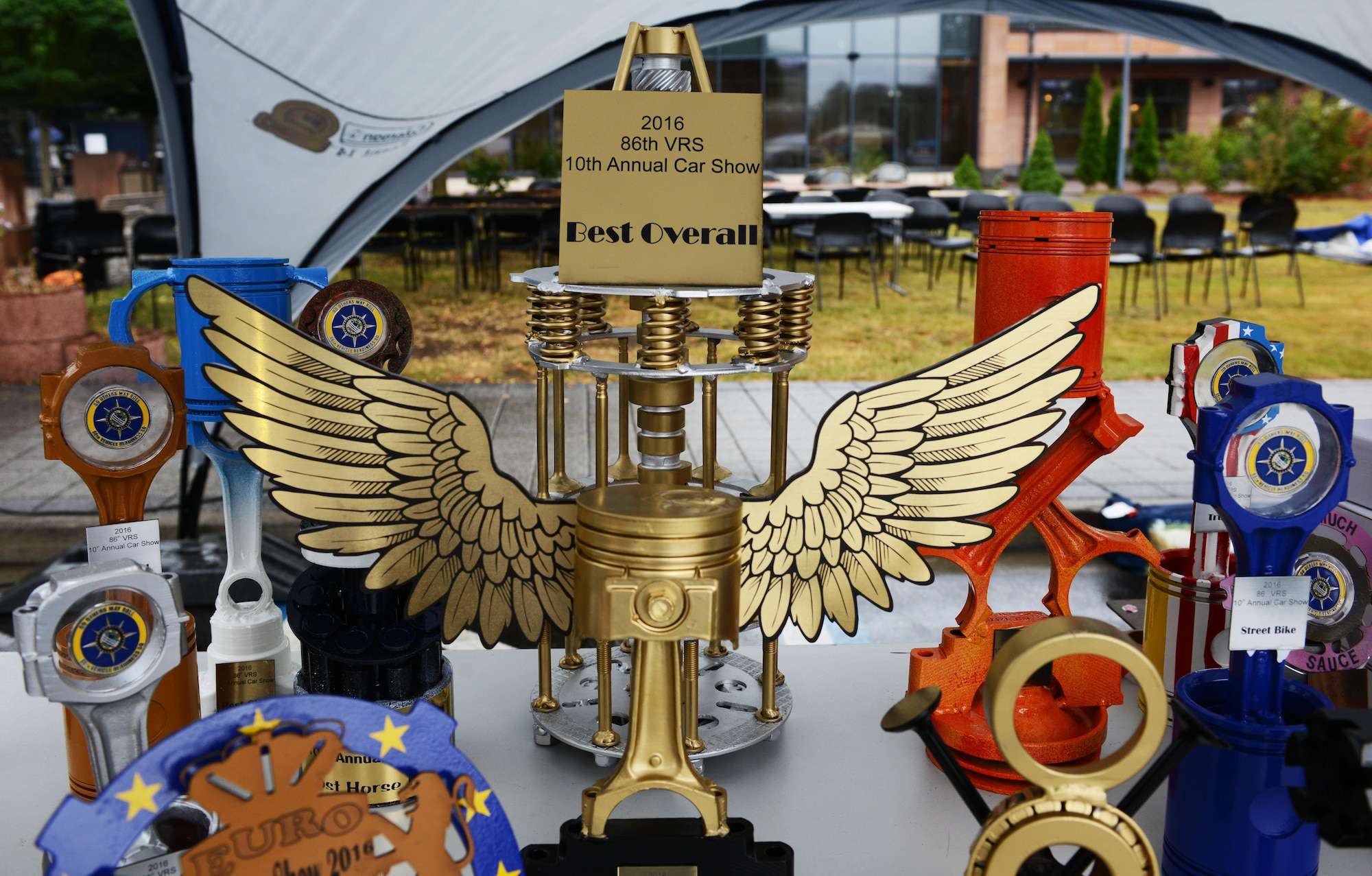 Trophies made from car parts rest on a table during a car show Aug. 20, 2016, at Ramstein Air Base, Germany. Winners received the trophies based on the appearance, physical condition, additional mechanical work on the engine and accessories added to their vehicles. (U.S. Air Force photo/ Airman 1st Class Joshua Magbanua)