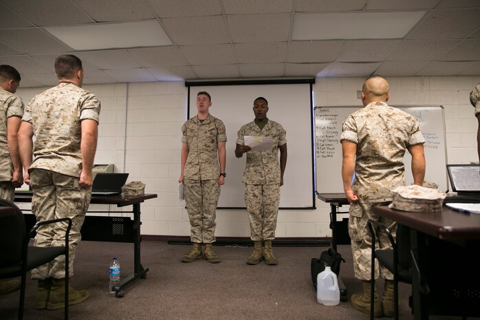 Lance Cpl. Mitchell Truex, left, and Lance Cpl. Nathaniel Slaney recite the Noncommissioned Officer's Creed in front of the students of Corporal's Course 3-16, aboard Camp Allen, Va., Aug. 18, 2016. Truex and Slaney were selected by their units to attend the U.S.  Marine Corps Forces Command Corporal’s Course 3-16 to develop leadership skills and responsibilities of NCOs. (Official U.S. Marine Corps photo by Sgt. Calvin Shamoon/ Released)