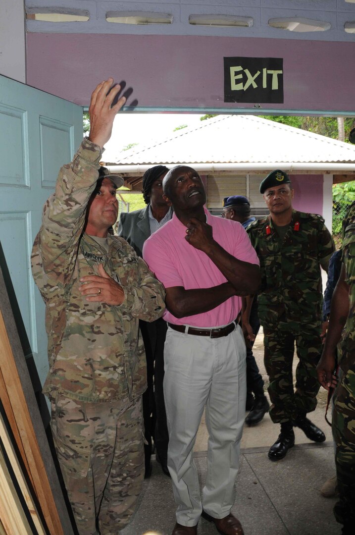 Chief Warrant Officer 4 Chris Krawczyk explains the repairs being made to the Blanchisseus Primary School to U.S. Ambassador to Trinidad Frank L. Estrada during a site visit on August 10, 2016. 