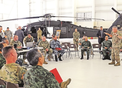 Maj. Gen.  Wayne W. Grigsby Jr., commanding general of the 1st Infantry Division and Fort Riley, provides an overview of 1st Combat Aviation Brigade, 1st Inf. Div., capabilities to the Fifth Army Inter-American Relations Program delegation on July 21 at Fort Riley. The delegation, led by Lt. Gen. Perry L. Wiggins, commander of U.S. Army North, and the Mexican air force Lt. Gen. Miguel Vallin, looked at aircraft and learned about the maintenance necessary to maintain the unit’s readiness.