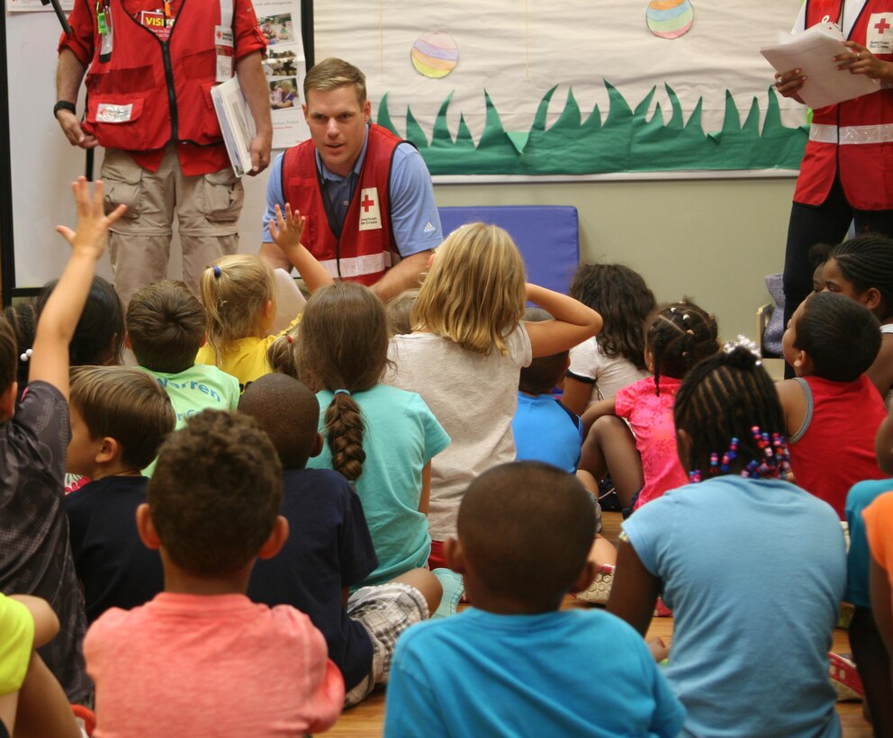 Red Cross volunteer John Miller talks to children at the Quantico Youth Center about hurricanes during a presentation of the Pillowcase Project August 8. 