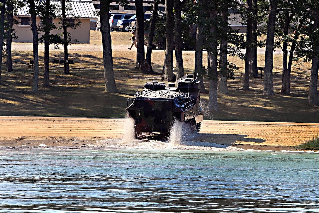 Marines inside an amphibious assault vehicle land ashore during amphibious assault training on Lake Margrethe during Exercise Northern Strike 16 at Camp Grayling, Mich., Aug. 11, 2016. Michigan Army National Guard photo by Sgt. 1st Class Helen Miller