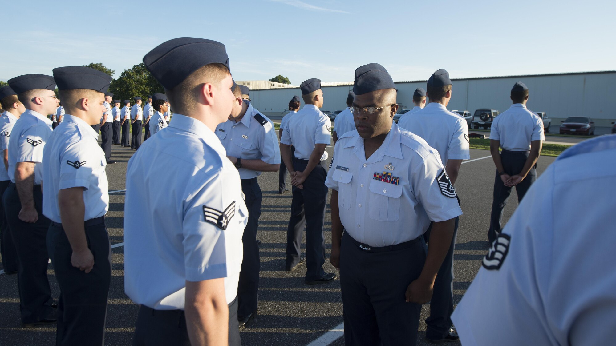 Master Sgt. Montrell Jones, 436th Logistics Readiness first sergeant, looks over an Airman’s uniform during an open-ranks inspection Aug. 17, 2016, on Dover Air Force Base, Del. An open-ranks inspection is used to ensure that Air Force Instruction 36-2903 is being adhered to. (U.S. Air Force photo/Senior Airman Zachary Cacicia)