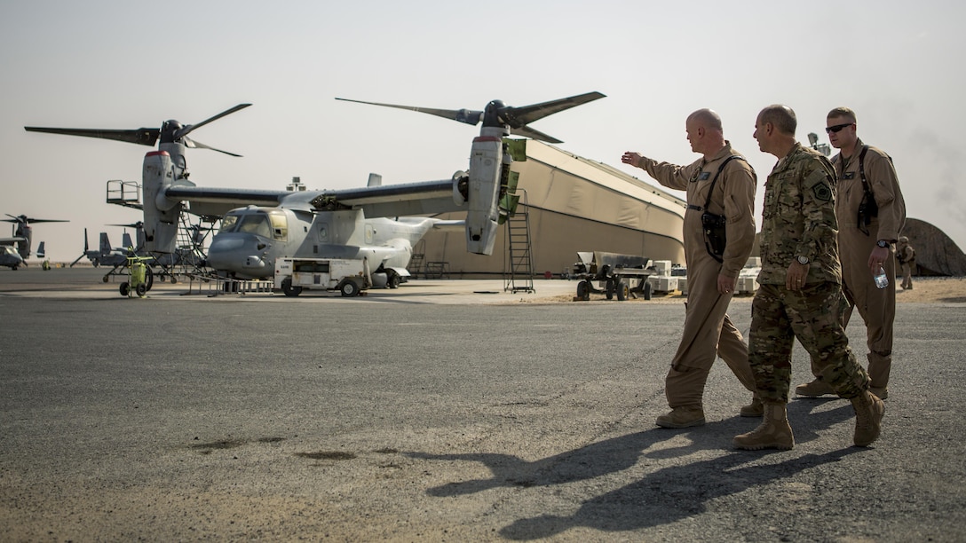 U.S. Air Force Lt. Gen. Jeffrey L. Harrigian, commander of U.S. Air Forces Central Command and Combined Forces Air Component, U.S. Central Command, tours the flight line of MV-22 Ospreys with U.S. Marine Lt. Col. James Hoffmann, commanding officer for Marine Medium Tiltrotor Squadron 363, Special Purpose Marine Air-Ground Task Force – Crisis Response – Central Command during a recent tour of the area of operations. USAFCENT and the CFACC oversees the development of contingency plans, conduct of air operations, and provides guidance for the coalition air campaign spanning 20 nations.