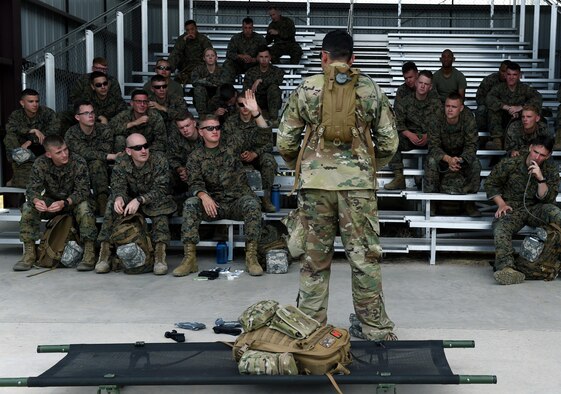 Senior Airman Ronnie Perez, 460TH Medical Operations Squadron medical technician, speaks to Company A, Marine Cryptologic Support Battalion members about the importance of knowing proper combat medicine skills Aug. 17, 2016, at the U.S. Air Force Academy, Colo. Perez taught MCSB proper techniques of controlling an airway, how to control severe bleeding, how to detect altitude sickness and how to treat orthopedic injuries. (U.S. Air Force Photo by Airman Holden S. Faul/ Released)