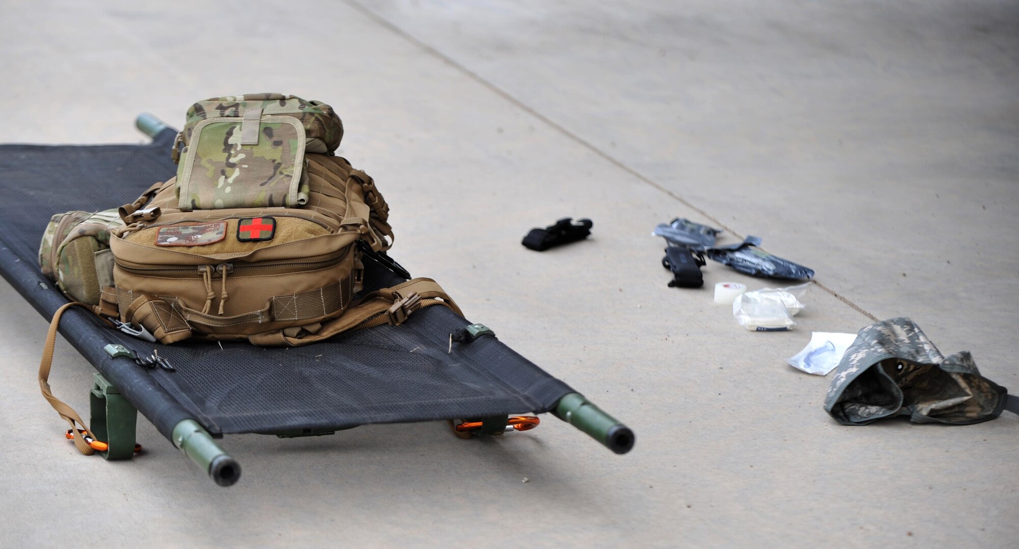 Senior Airman Ronnie Perez, 460th Medical Operations Squadron medical technician, displays his medical gear prior to beginning his combat medicine lesson for Company A, Marine Cryptologic Support Battalion Aug. 17, 2016, at the U.S. Air Force Academy, Colo. Perez is certified as an Emergency Medical Technician and Self Aid Buddy Care instructor through the U.S. Air Force. (U.S. Air Force photo by Airman Holden S. Faul/ Released