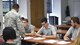 Master Sgt. Joseph Poltor, a Youngstown Air Reserve Station recruiter, guides Dan Madeline, Cross Scarpaci and Michael Amato through enlistment paperwork here, Aug. 19, 2016. The three new Airmen took the oath of enlistment surrounded by friends and family to begin their Air Force Reserve careers. Poltor recently made 150 percent of his recruitment quota, becoming the third Youngstown recruiter in recent history to reach the century club. (U.S. Air Force photo/Eric White)