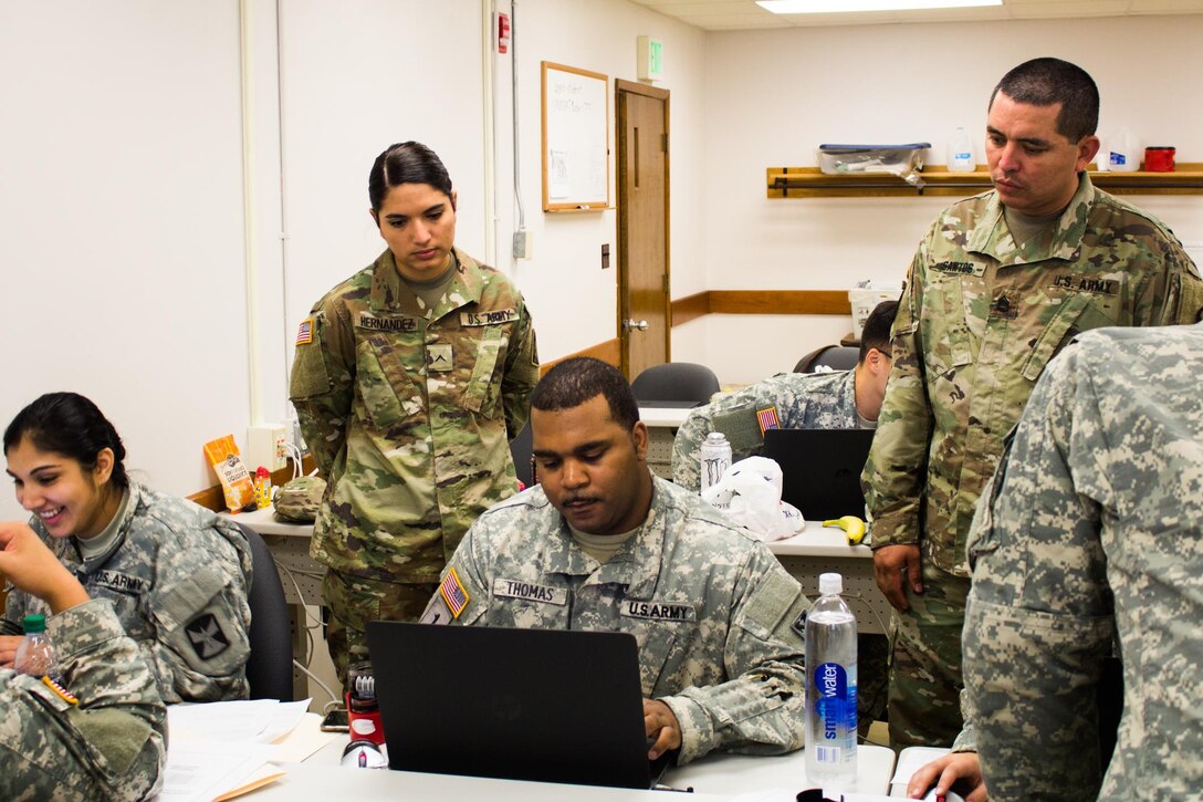 FORT MCCOY, Wis. – U.S. Army Soldier, Sgt. 1st Class Melvin Santos, (right), of U.S. Army Financial Management Command instructs Soldiers from U.S. Army Reserve, National Guard, and Active components how to process commercial vendor services. Exercise Diamond Saber August 2016 uses multiple scenarios to help Soldiers increase their skills in finance management. (U.S. Army Reserve Sgt. Clinton Massey, 206th Broadcast Operations Detachment)