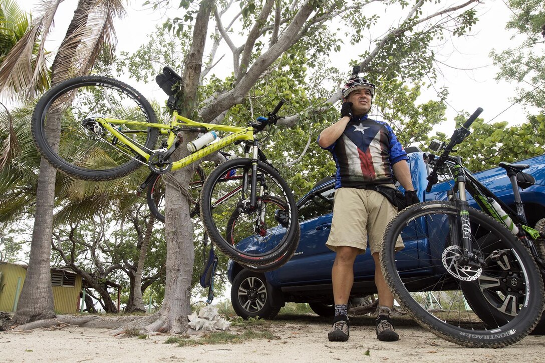 Iraqi Freedom veteran Army Staff Sgt. Carlos Labarca unclips his helmet after a mountain bike ride with the Warriors 4 Life veterans group in Cabo Rojo, Puerto Rico, Aug. 13, 2016. DoD photo by EJ Hersom
