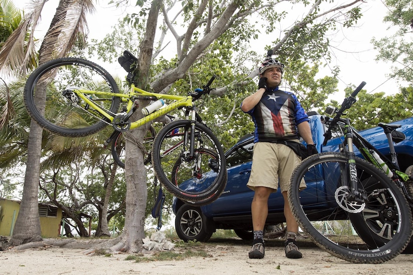 Iraqi Freedom veteran Army Staff Sgt. Carlos Labarca unclips his helmet after a mountain bike ride with the Warriors 4 Life veterans group in Cabo Rojo, Puerto Rico, Aug. 13, 2016. DoD photo by EJ Hersom
