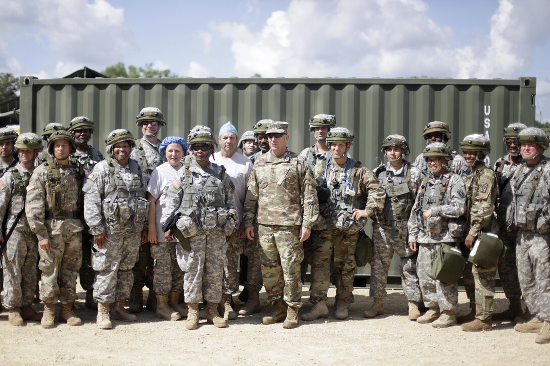 U.S. Army Reserve Soldiers pose for a photo with US Army Forces Command (FORSCOM) Commander, Gen. Robert Abrams, at Forward Operating Base Justice on Fort McCoy, Wis. on August 18, 2016. Nearly 7,000 service members from across the country are participating in the 86th Training Division's Combat Support Training Exercise at Fort McCoy, Wis. More than 100 units from across the Army, the Air Force, the Navy, the Marines, and the Canadian Army are training at the 84th Training Command's final exercise of 2016. (U.S. Army Photo by Sgt. Tierney P. Curry/Released)