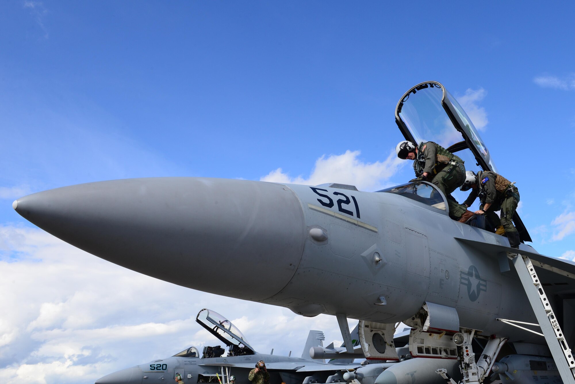 U.S. Navy Lt. Samuel Deedy, a pilot assigned to Electronic Attack Squadron (VAQ) 135, Naval Air Station (NAS) Whidbey Island, Wash., seats himself in an EA-18G Growler aircraft along with Royal Australian Air Force (RAAF) Flt. Lt. Conrad Stalling, an electronic warfare officer assigned to RAAF Base Williamtown, New South Wales, attached to VAQ-135, NAS Whidbey Island, Wash., Aug. 16, 2016, during RED FLAG-Alaska 16-3, at Eielson Air Force Base, Alaska. Deedy was born and raised in Wasilla, Alaska, and said he ahs dreamt of becoming a pilot for as long as he can remember. (U.S. Air Force photo by Airman 1st Class Cassandra Whitman)