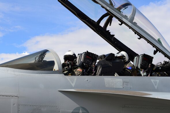 U.S. Navy Lt. Samuel Deedy, a pilot assigned to Electronic Attack Squadron (VAQ) 135, Naval Air Station (NAS) Whidbey Island, Wash., communicates with aircrew members through his mask in an EA-18G Growler aircraft along with Royal Australian Air Force (RAAF) Flt. Lt. Conrad Stalling, an electronic warfare officer assigned to RAAF Base Williamtown, New South Wales, attached to VAQ-135, NAS Whidbey Island, Wash., Aug. 16, 2016, during RED FLAG-Alaska 16-3, at Eielson Air Force Base, Alaska. Deedy received his pilot’s license from Palmer, Alaska more than nine years ago and said flying the EA-18G Growler is very different than flying a Cessna 152. (U.S. Air Force photo by Airman 1st Class Cassandra Whitman)