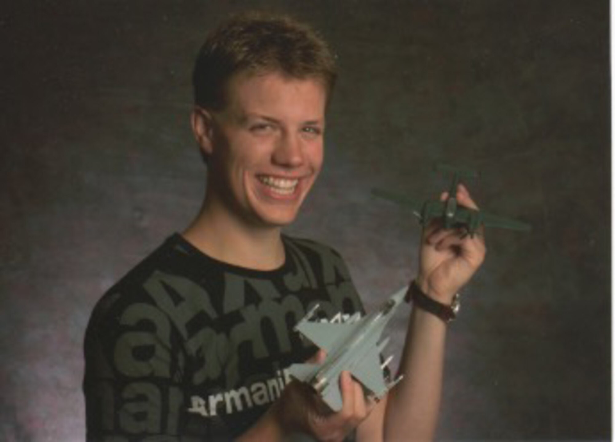 Seventeen-year-old U.S. Navy Lt. Samuel Deedy shows off two model aircraft. When Deedy was younger, he often brought home books from the library about the history of aviation and built military-related models. (Courtesy photo)