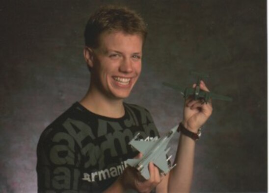 Seventeen-year-old U.S. Navy Lt. Samuel Deedy shows off two model aircraft. When Deedy was younger, he often brought home books from the library about the history of aviation and built military-related models. (Courtesy photo)