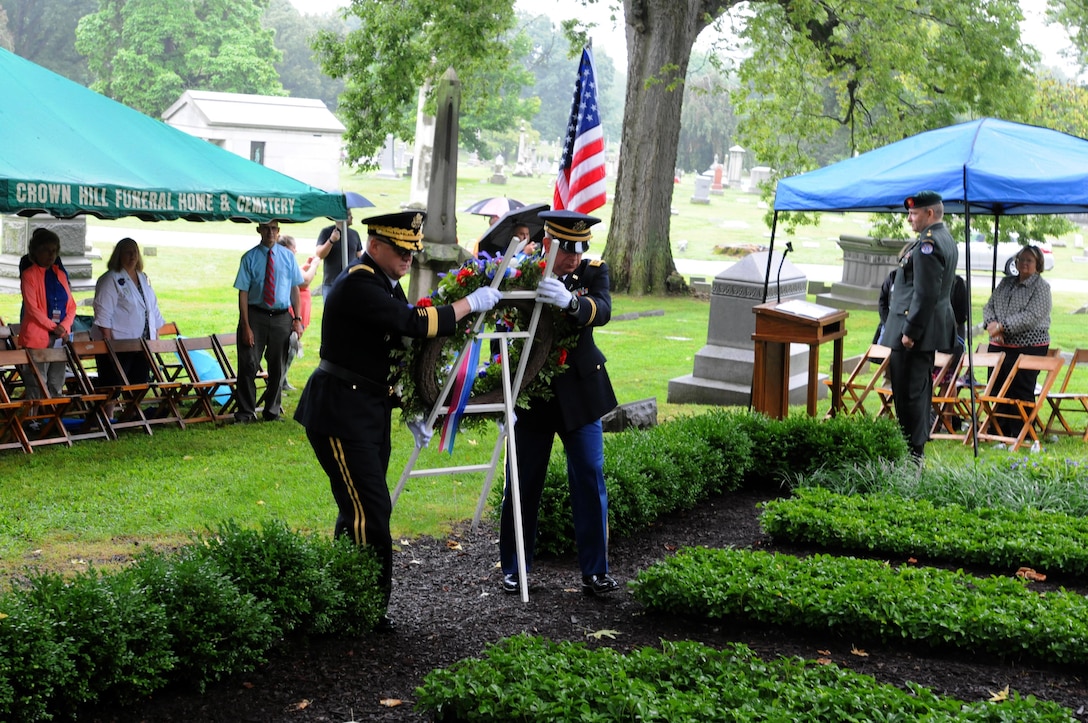 Brigadier Gen. Stephen E. Strand, left, deputy commanding general, 88th Regional Support Command, and Chaplain (Maj.) Scott Hagen, deputy command chaplain, 88th RSC, move the wreath into position at the Benjamin Harrison Memorial at the Crown Hill Cemetery in Indianapolis, August 20. The ceremony celebrated the presidency, life and legacy of the 23rd President of the United States.