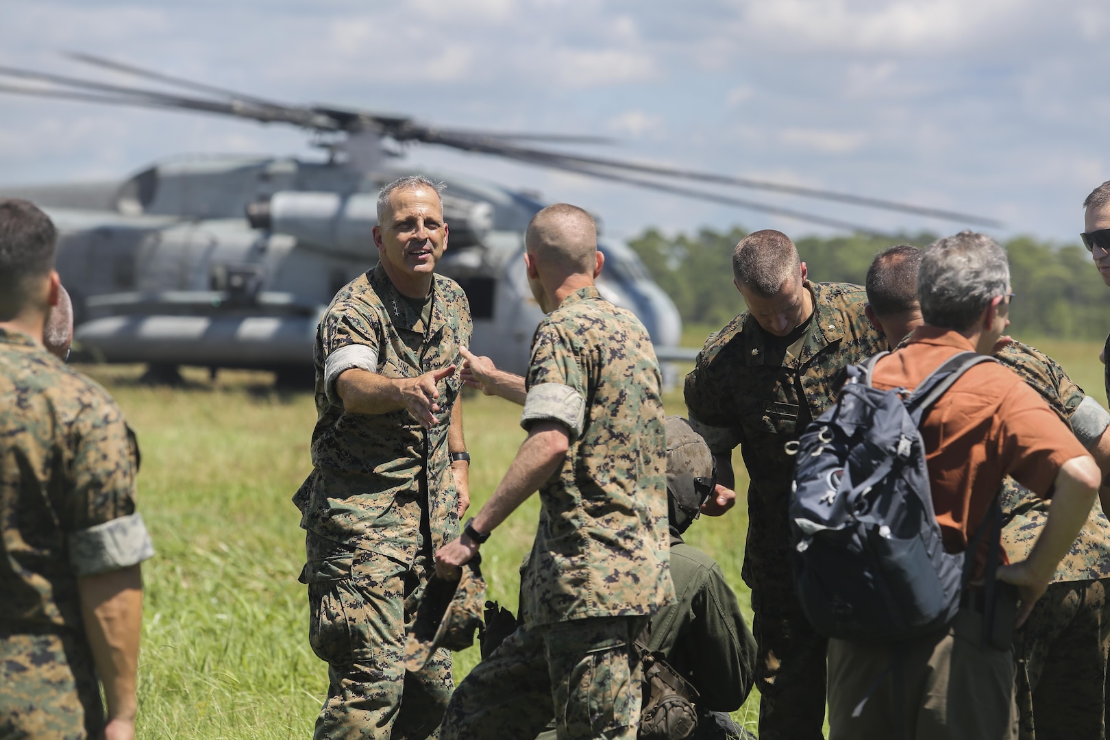 Lt. Gen. Michael Dana, center-left, Deputy Commandant of Installations and Logistics, shakes hands with Col. Mathew Reuter, center, commanding officer of Combat Logistics Regiment 25, at Camp Lejeune, N.C., Aug. 17. Dana visited various units throughout II Marine Expeditionary Force to observe advancements in logistical technology. (U.S. Marine Corps photo by Sgt. Lucas Hopkins)