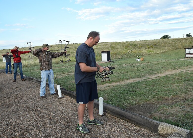 SCHRIEVER AIR FORCE BASE, Colo. – Andy Roland, Aerospace Corporation contractor, Zachary Miller, 50th Security Forces Squadron and Peter Orsi, Space Warning and Surveillance Division, take their shots during the archery competition at Schriever Air Force Base, Friday, Aug. 19, 2016. Orsi took first place while Miller took second. Roland, a veteran in the tournament, placed in the top three last year. (U.S. Air Force photo/Staff Sgt. Matthew Coleman-Foster)