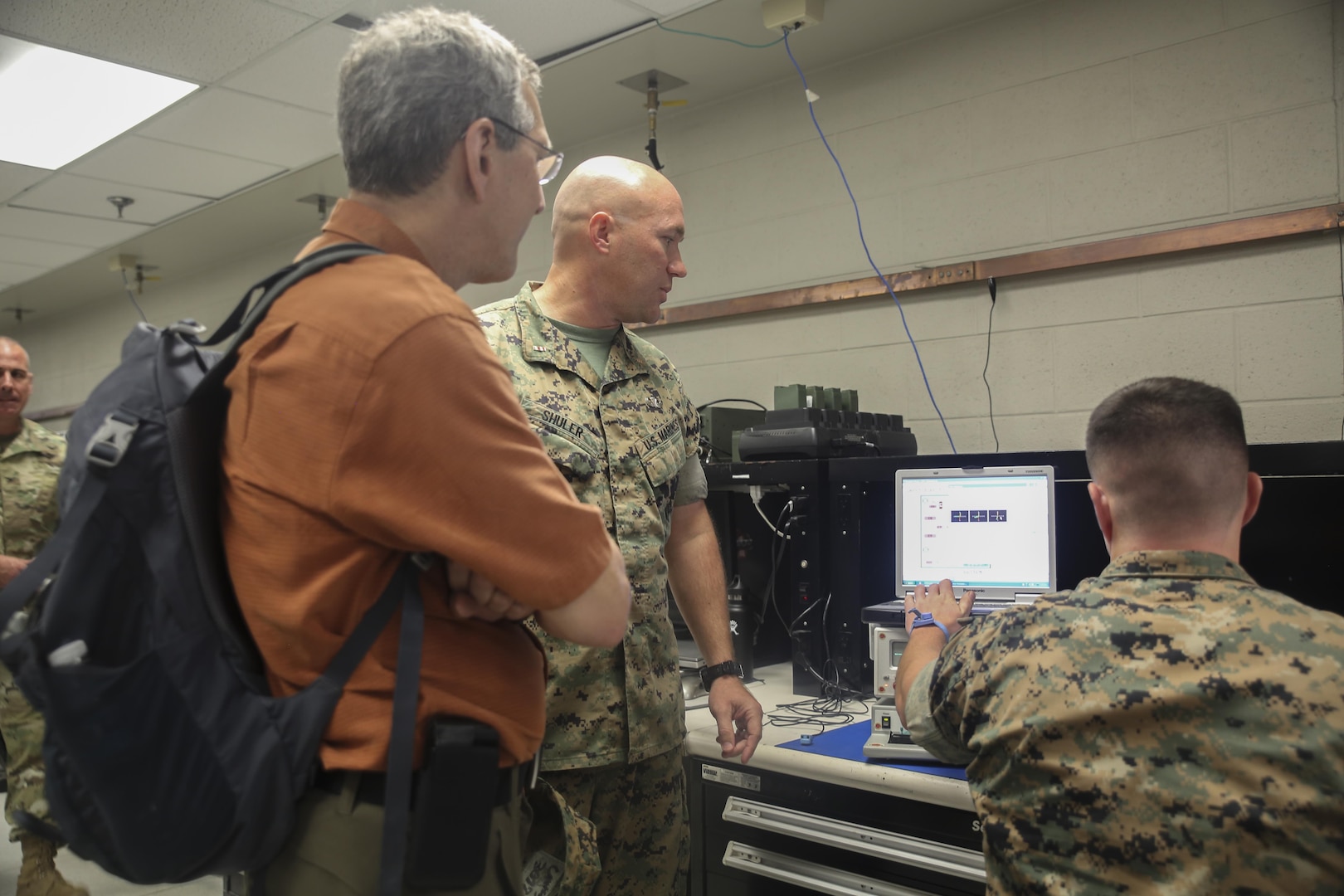 Alan Estevez, left, Principal Deputy under Secretary of Defense for Acquisition, Technology and Logistics, observes a Marine conduct electronic maintenance at Camp Lejeune, N.C., Aug. 17. Several distinguished visitors from the Department of Defense visited Camp Lejeune and the USNS Wright to observe technological innovation enhancing logistical capabilities throughout II Marine Expeditionary Force. (U.S. Marine Corps photo by Sgt. Lucas Hopkins)