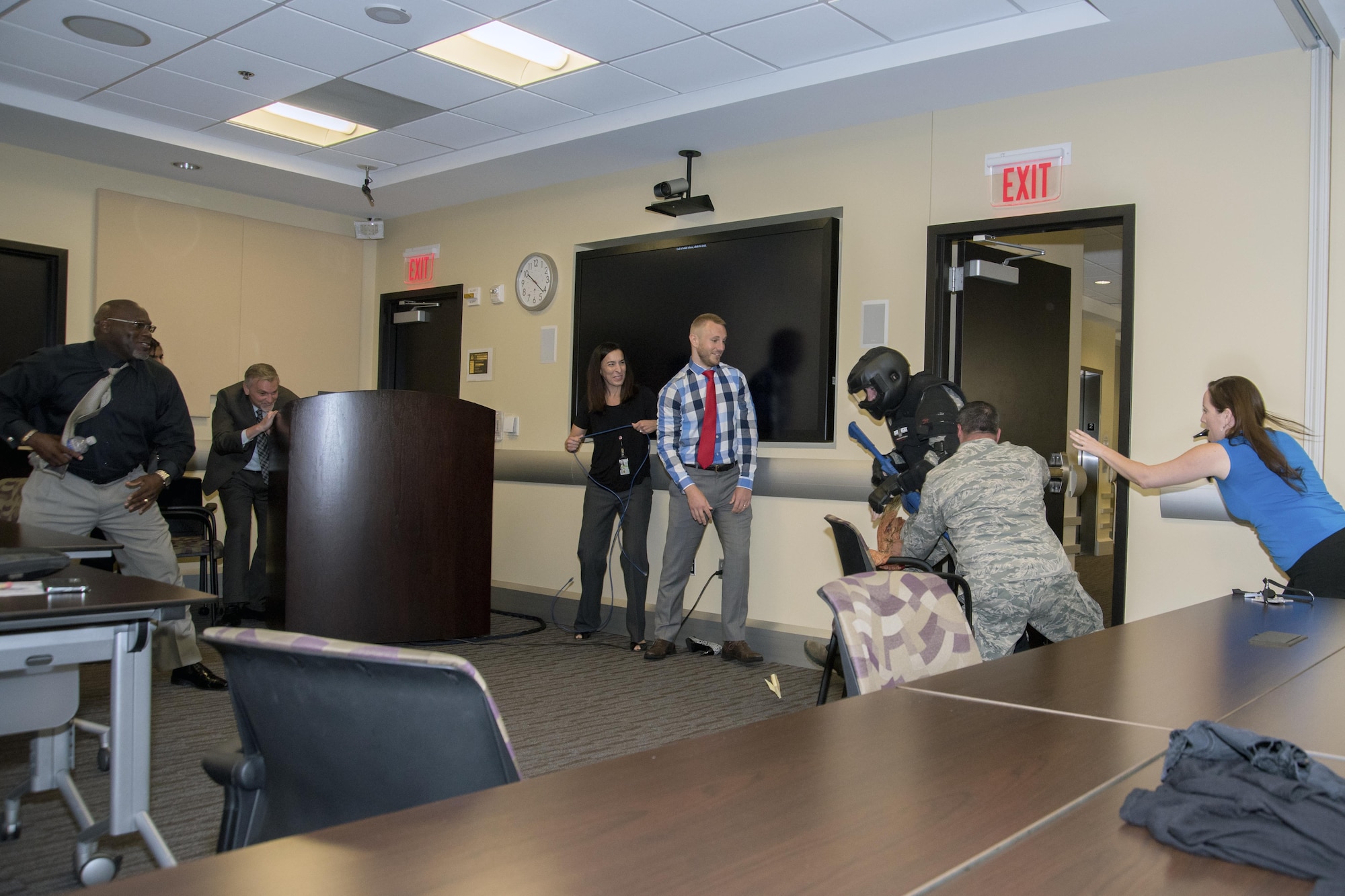 Members of Joint Base Andrews, Md., attack Tech. Sgt. Logan Ray, 11th Security Support Squadron assistant NCO in charge of training, during an active shooter training scenario at the Jacob E. Smart Building on base, Aug. 17, 2016. The training, held by the 11th SSPTS, instructed attendees on how to react during an active shooter incident in specific office locations. (U.S. Air Force photo by Airman Gabrielle Spalding)