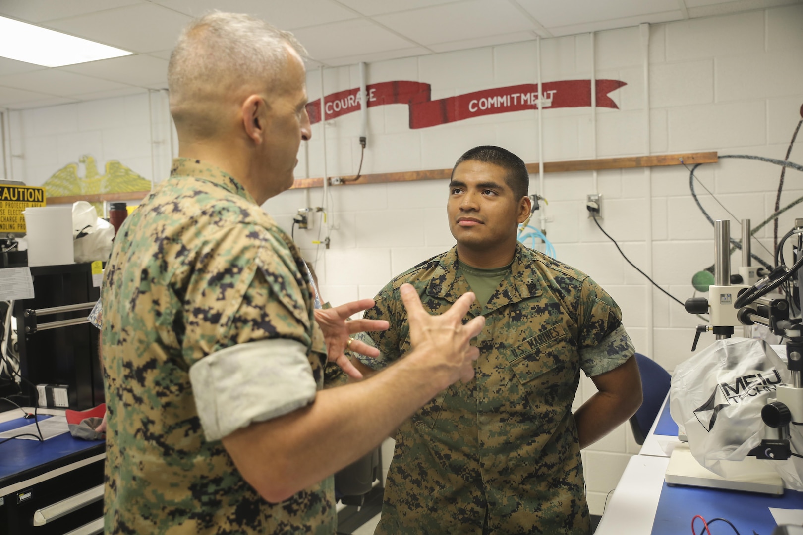 Lt. Gen. Michael Dana, left, Deputy Commandant of Installations and Logistics, speaks to Cpl. Edwin Flores, a telephone systems and personal computer intermediate repairer with 2nd Maintenance Battalion, at Camp Lejeune, N.C., Aug. 17. Dana was accompanied by several other distinguished visitors from the Department of Defense, who observed technological advancements in the logistical components throughout II Marine Expeditionary Force. (U.S. Marine Corps photo by Sgt. Lucas Hopkins)