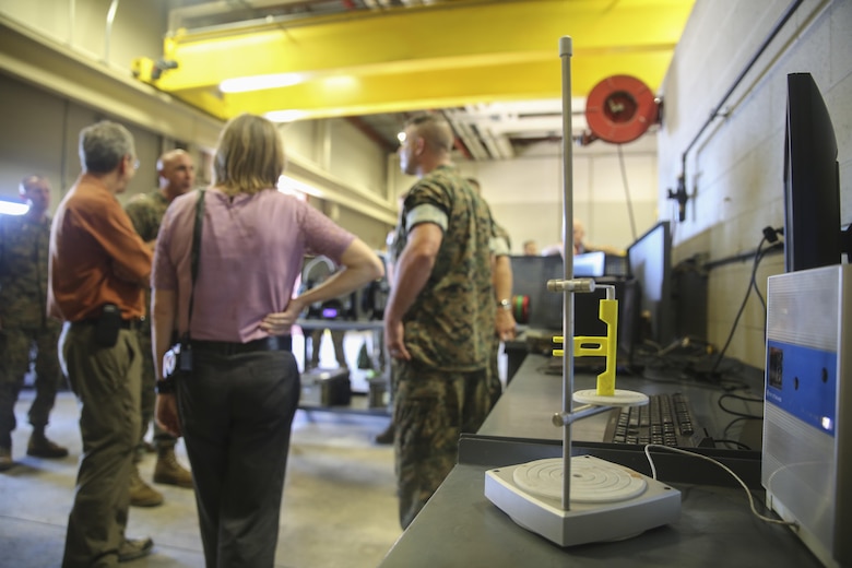 Distinguished visitors from the Department of Defense speak with Marines from 2nd Maintenance Battalion following a demonstration of 3D printing and additive manufacturing technology at Camp Lejeune, N.C., Aug. 17. Technological advancements such as 3D/AM printing has the potential to vastly reduce the time required to acquire small spare parts for vehicles and other equipment. Alan Estevez, Principal Deputy under Secretary of Defense for Acquisition, Technology and Logistics, Kristin French, Principal Deputy under Secretary of Defense for Logistics and Material readiness, and Lt. Gen. Michael Dana, Deputy Commandant of Installations and Logistics, visited the base to observe logistical innovation throughout II Marine Expeditionary Force. (U.S. Marine Corps photo by Sgt. Lucas Hopkins)