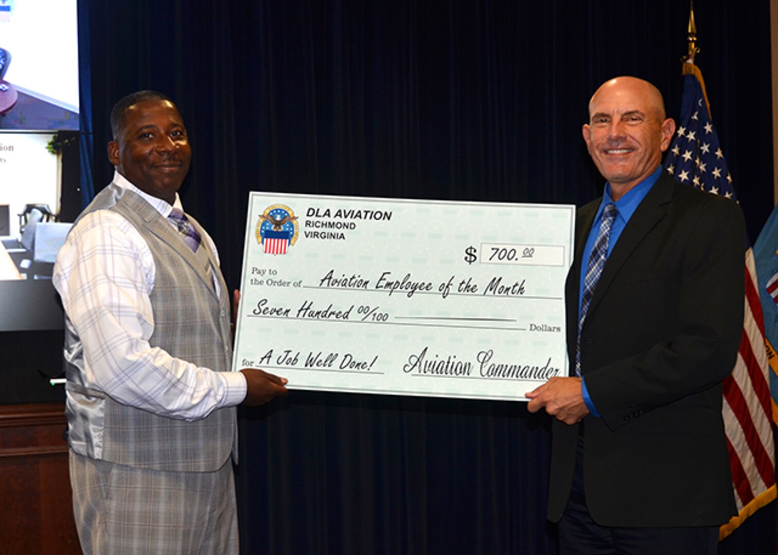 Defense Logistics Agency Aviation’s May Employee of the Month Award is presented to Keith McEachern during a ceremony Aug.18, 2016, at Defense Supply Center Richmond, Virginia. DLA Aviation’s Deputy Commander Charlie Lilli presents the award to McEachern who is a weapon systems program manager of the Inter-Continental Ballistic Missiles for DLA Aviation’s Customer Operations Directorate. 