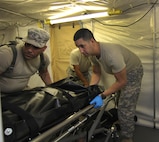 (right) US Army Reserve Spc. Reinaldo Sanchez, a mortuary affairs specialist with the 311th Quartermaster Company – Mortuary Affairs (MA), Puerto Rico, with help of fellow Soldiers secures human remains in a cooler located inside a Mobile Integrated Remains Collection System (MIRCS) during a Mortuary Affairs Exercise (MAX) at Fort Pickett, Aug. 17, 2016. (US Army Reserve Photo by Sgt. Quentin Johnson, 211th MPAD/Released)