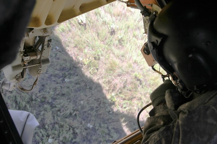 FORT MCCOY, Wis. -- Sgt. 1st Class Michael Noche (right), a CH-47 Chinook helicopter mechanic from Bravo Company, 7th Battalion, 158th Aviation Regiment out of Olathe, Kan., monitors a crate of MREs attached to one of the undercarriage sling hooks of the helicopter as part of the Combat Support Training Exercise at Fort McCoy, Wis., on Aug. 17, 2016. CSTX immerses Army Reserve Soldiers and other service members in real-world training scenarios to enhance unit readiness in the planning, preparation, and execution of combat service support operations. (U.S. Army Reserve photo by Spc. Christopher A. Hernandez, 345th Public Affairs Detachment)