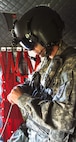 FORT MCCOY, Wis. -- Staff Sgt. Ryan Elkins, a CH-47 Chinook helicopter mechanic from Bravo Company, 7th Battalion, 158th Aviation Regiment out of Olathe, Kan., connects his aviation headset prior to depature as part of the Combat Support Training Exercise at Fort McCoy, Wis., on Aug. 17, 2016. CSTX immerses Army Reserve Soldiers and other service members in real-world scenarios to enhance unit readiness in the planning, preparation, and execution of combat service support operations. (U.S. Army Reserve photo by Spc. Christopher A. Hernandez, 345th Public Affairs Detachment)