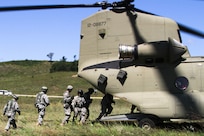 FORT MCCOY, Wis. -- Army Reserve Soldiers from the 824th Quartermaster Company out of Fort Bragg, N.C., proceed to board the rear cabin of the CH-47 Chinook as part of the Combat Support Training Exercise at Fort McCoy, Wis., on Aug. 17, 2016. CSTX immerses Army Reserve Soldiers and other service members in real-world training scenarios to enhance unit readiness in the planning, preparation, and execution of combat service support operations. (U.S. Army Reserve photo by Spc. Christopher A. Hernandez, 345th Public Affairs Detachment)