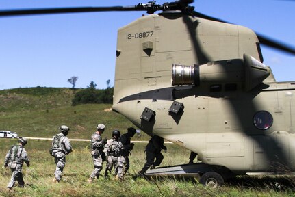 FORT MCCOY, Wis. -- Army Reserve Soldiers from the 824th Quartermaster Company out of Fort Bragg, N.C., proceed to board the rear cabin of the CH-47 Chinook as part of the Combat Support Training Exercise at Fort McCoy, Wis., on Aug. 17, 2016. CSTX immerses Army Reserve Soldiers and other service members in real-world training scenarios to enhance unit readiness in the planning, preparation, and execution of combat service support operations. (U.S. Army Reserve photo by Spc. Christopher A. Hernandez, 345th Public Affairs Detachment)