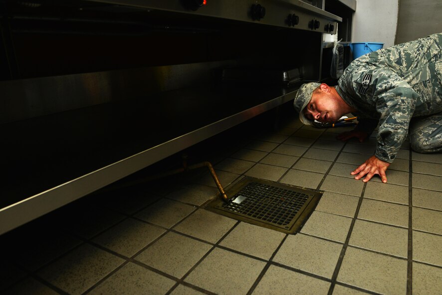 U.S. Air Force Staff Sgt. Jonathan Lucero, 20th Civil Engineer Squadron water and fuel systems maintenance craftsman, inspects a broken drain pipe in the Chief Master Sgt. Emerson E. Williams Dining Facility at Shaw Air Force Base, S.C., Aug. 18, 2016. The 20th CES water and fuel systems flight is responsible for maintaining plumbing, water and gas systems, and fire suppression systems around the base. (U.S. Air Force photo by Airman 1st Class Destinee Sweeney)