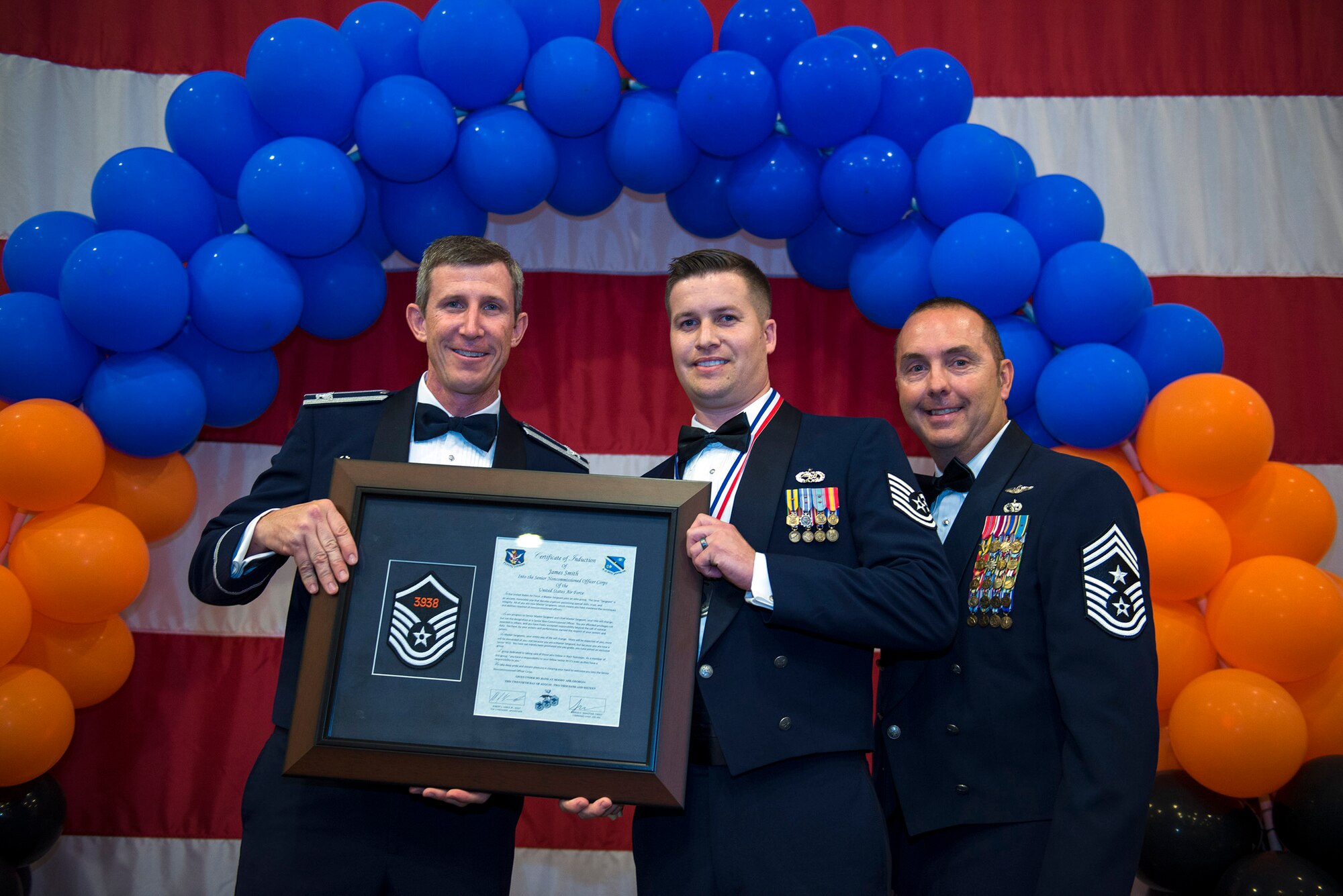 U.S. Air Force Master Sgt. James Smith, 23d Equipment Maintenance Squadron assistant first sergeant, receives a plaque during a Senior NCO Induction Ceremony, Aug. 20, 2016, at Moody Air Force Base, Ga. The inductee’s plaques included the master sergeant chevrons with their line number and a certificate honoring their promotion. (U.S. Air Force photo by Airman 1st Class Greg Nash)