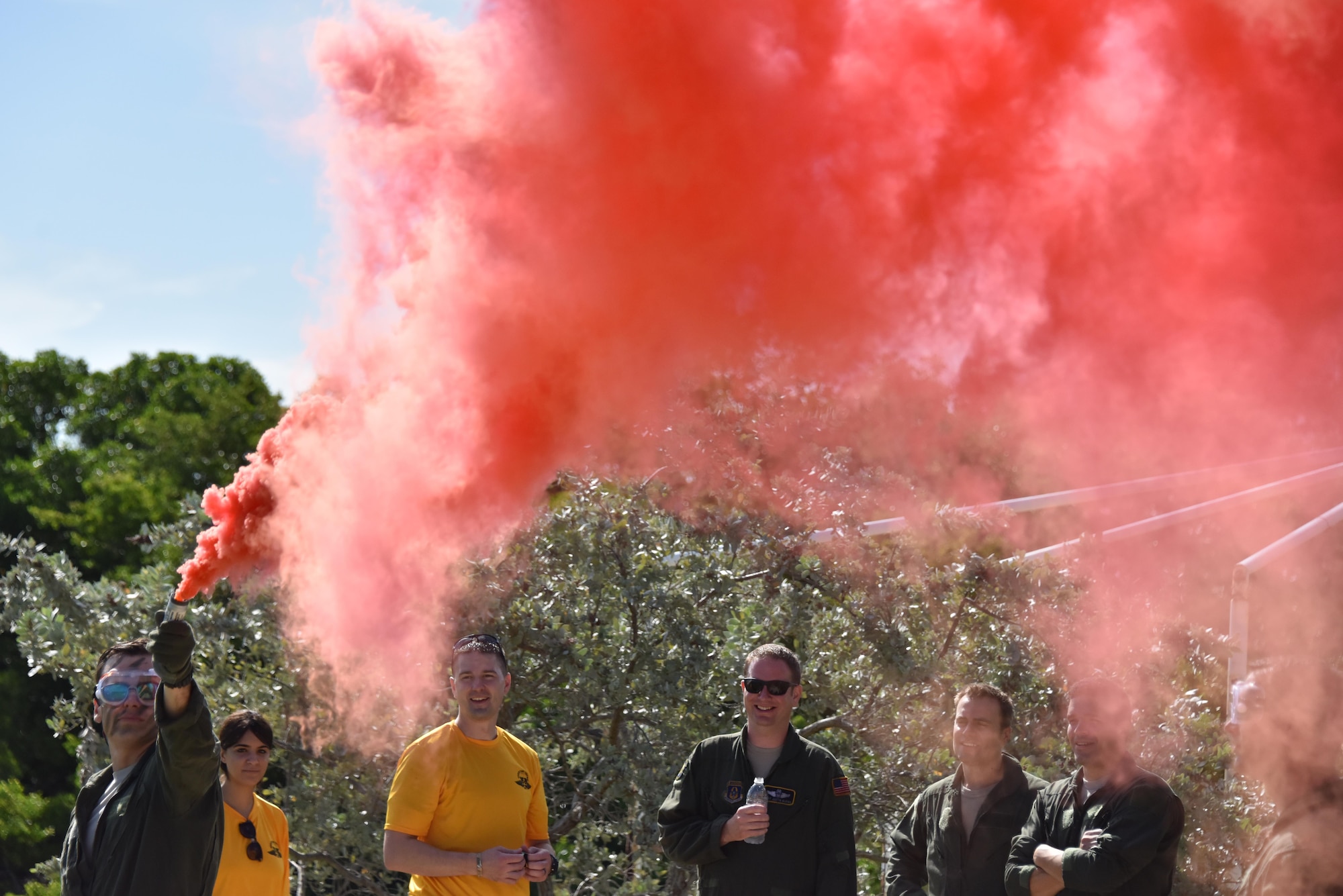 1st Lt. William Kammerer, III., pilot with the 911th Operations Group, demonstrates an orange smoke flare during survival training at Naval Air Station Key West, Florida, August 18, 2016. Airmen were given refresher training on how to use and operate several pieces of equipment, including different types of flares. (U.S. Air Force photo by Staff Sgt. Marjorie A. Bowlden)
