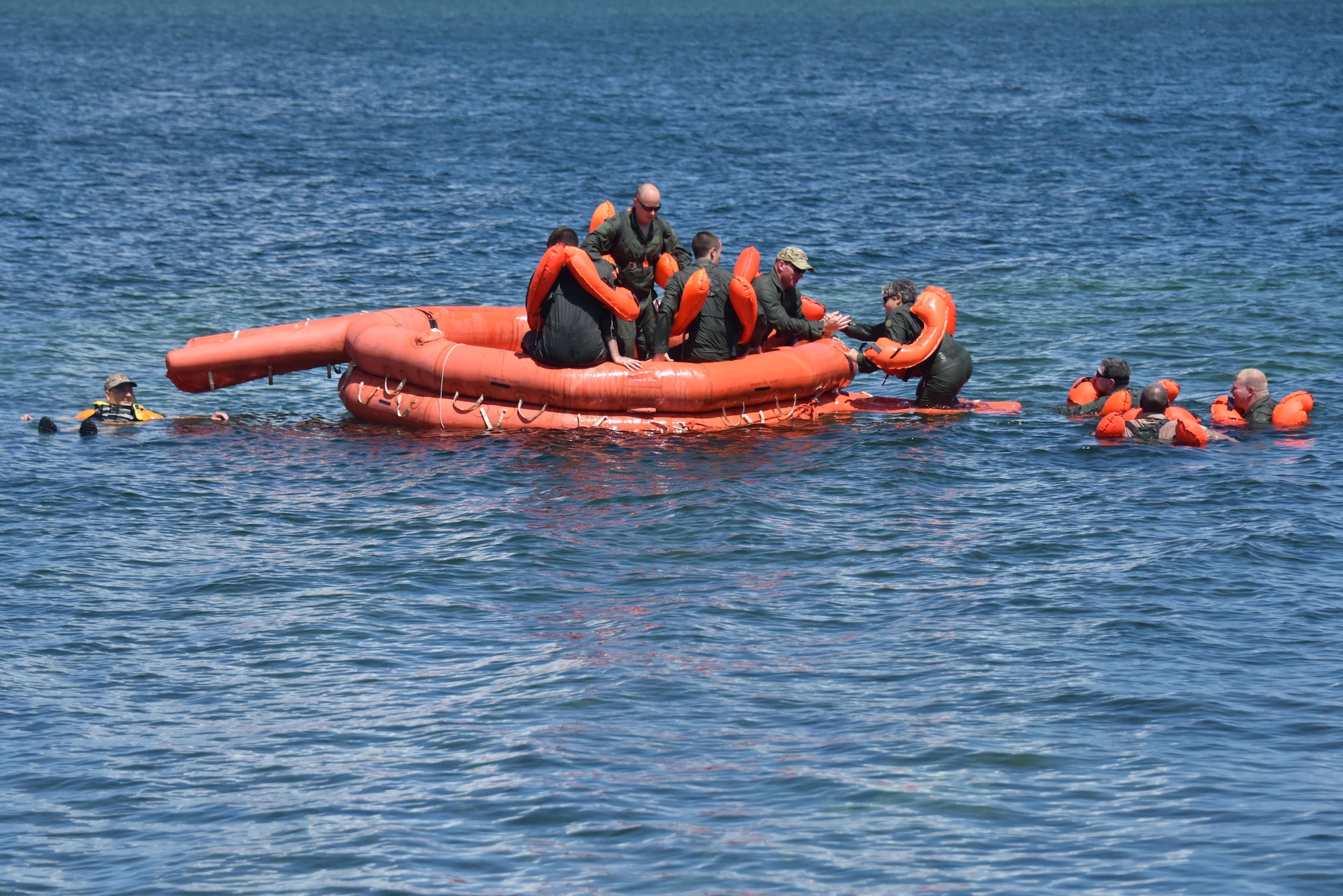 Master Sgt. Jackie Kupetz, load master with the 911th Operations Group, boards a 20-man life raft with the assistance of her fellow Airmen during water survival training at Naval Air Station Key West, Florida, August 18, 2016. Airmen got acquainted with several pieces of survival equipment during the training so that they would know how to react in a life-or-death situation. (U.S. Air Force photo by Staff Sgt. Marjorie A. Bowlden)